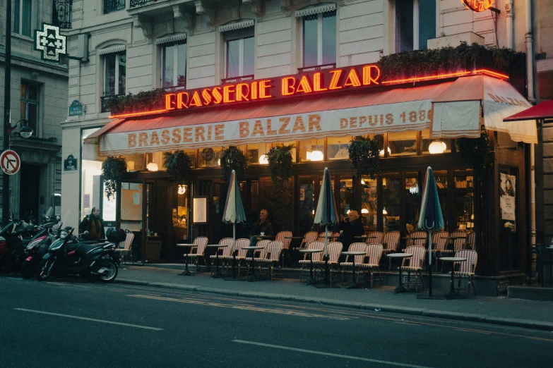 some buildings and tables with white tables and chairs