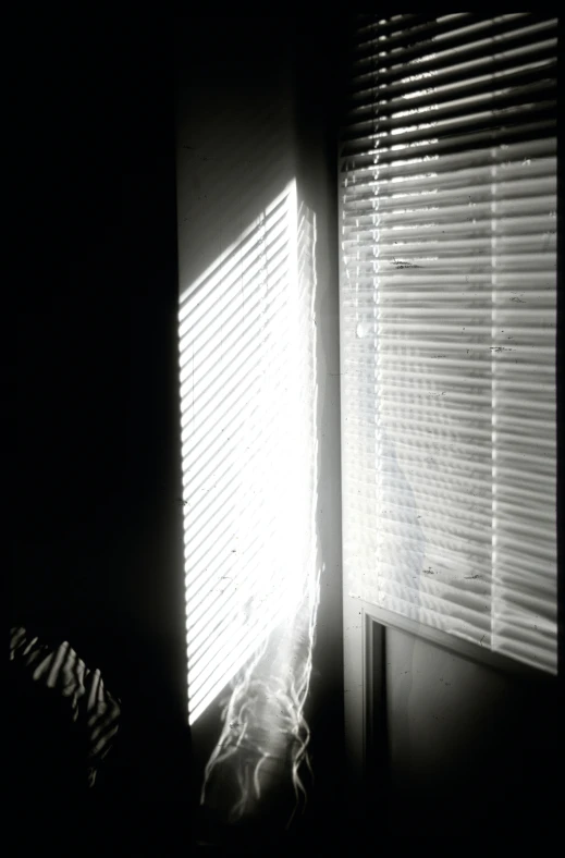 a window with a curtain partially covering it