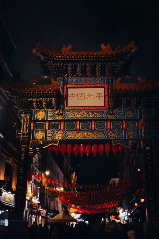 the entrance to an asian building at night