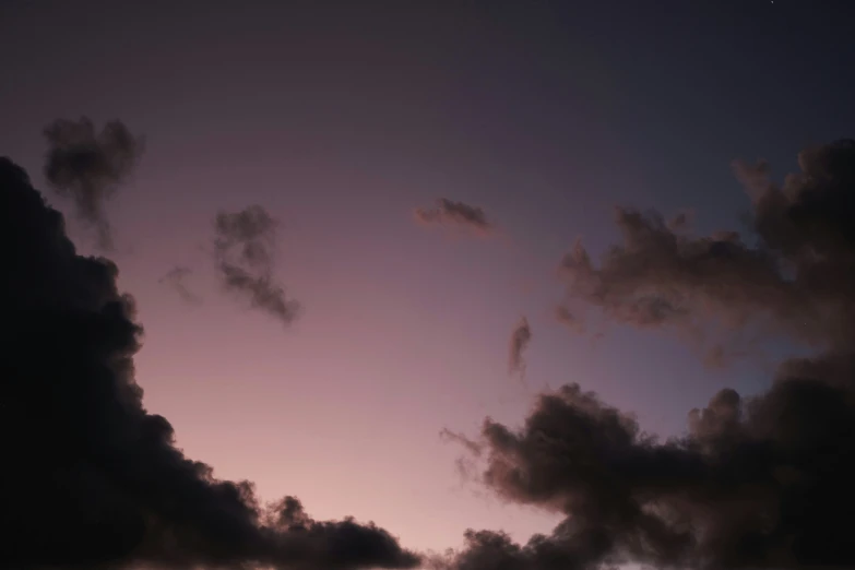 a airplane is flying through the sky with clouds