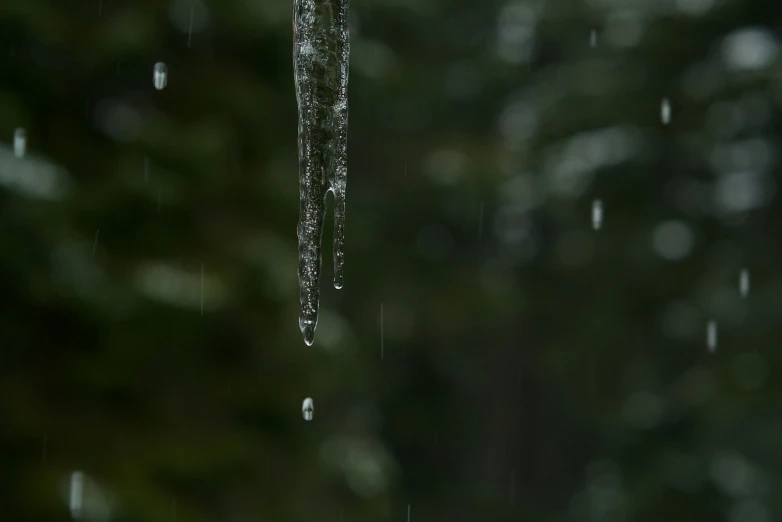 water pouring from umbrella on wet surface during day