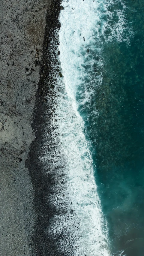 water crashing into a beach on a sunny day