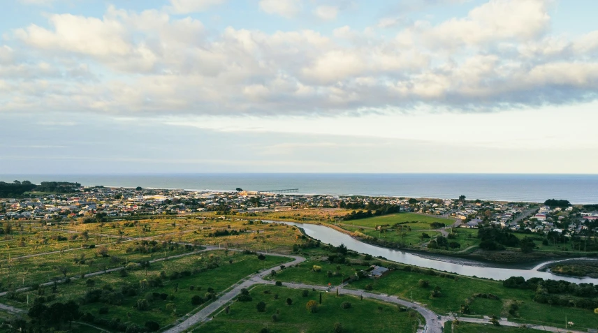 an aerial view of the ocean and surrounding town