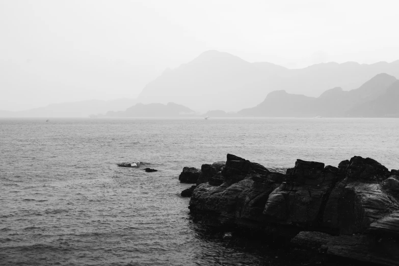 black and white po of rock formations in the water