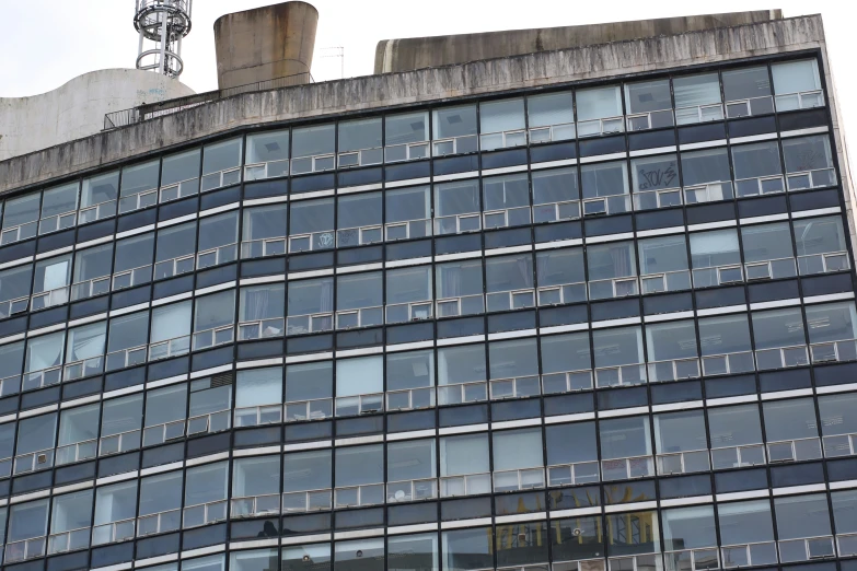 the side of an office building with a clock on top