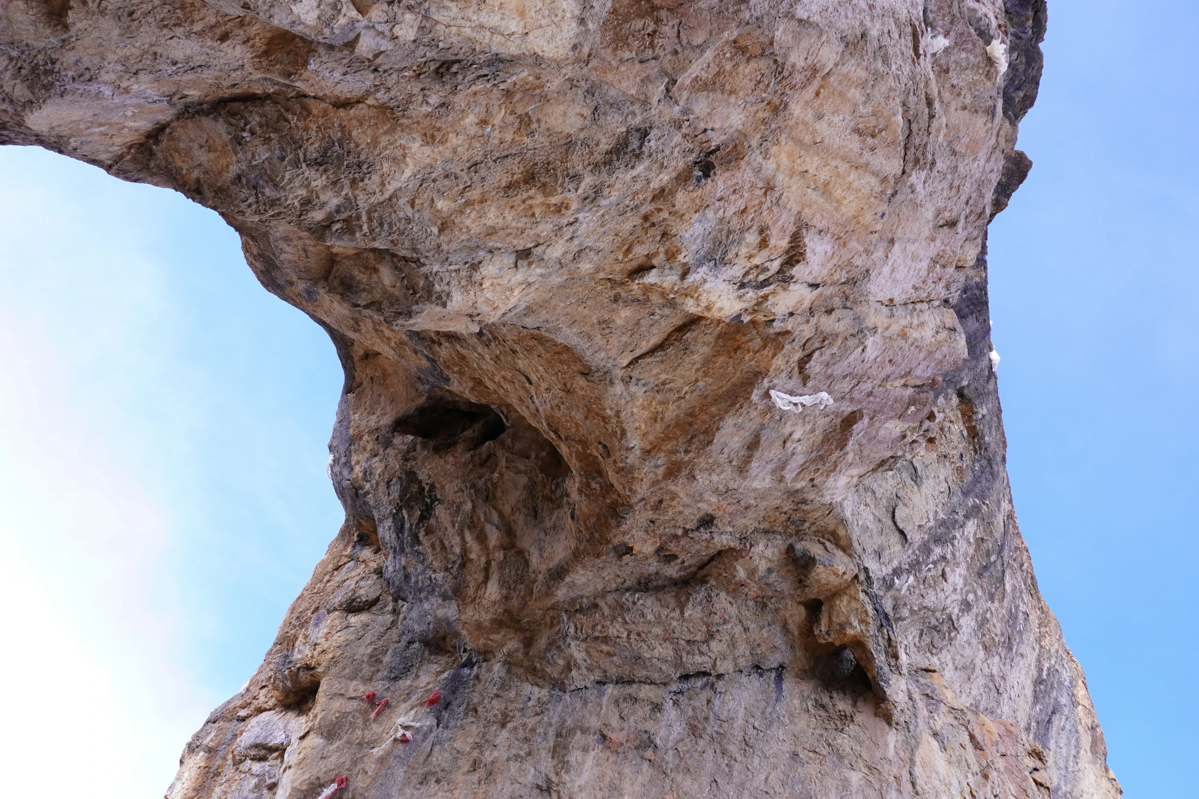 an image of a tall stone rock that has some rocks on it