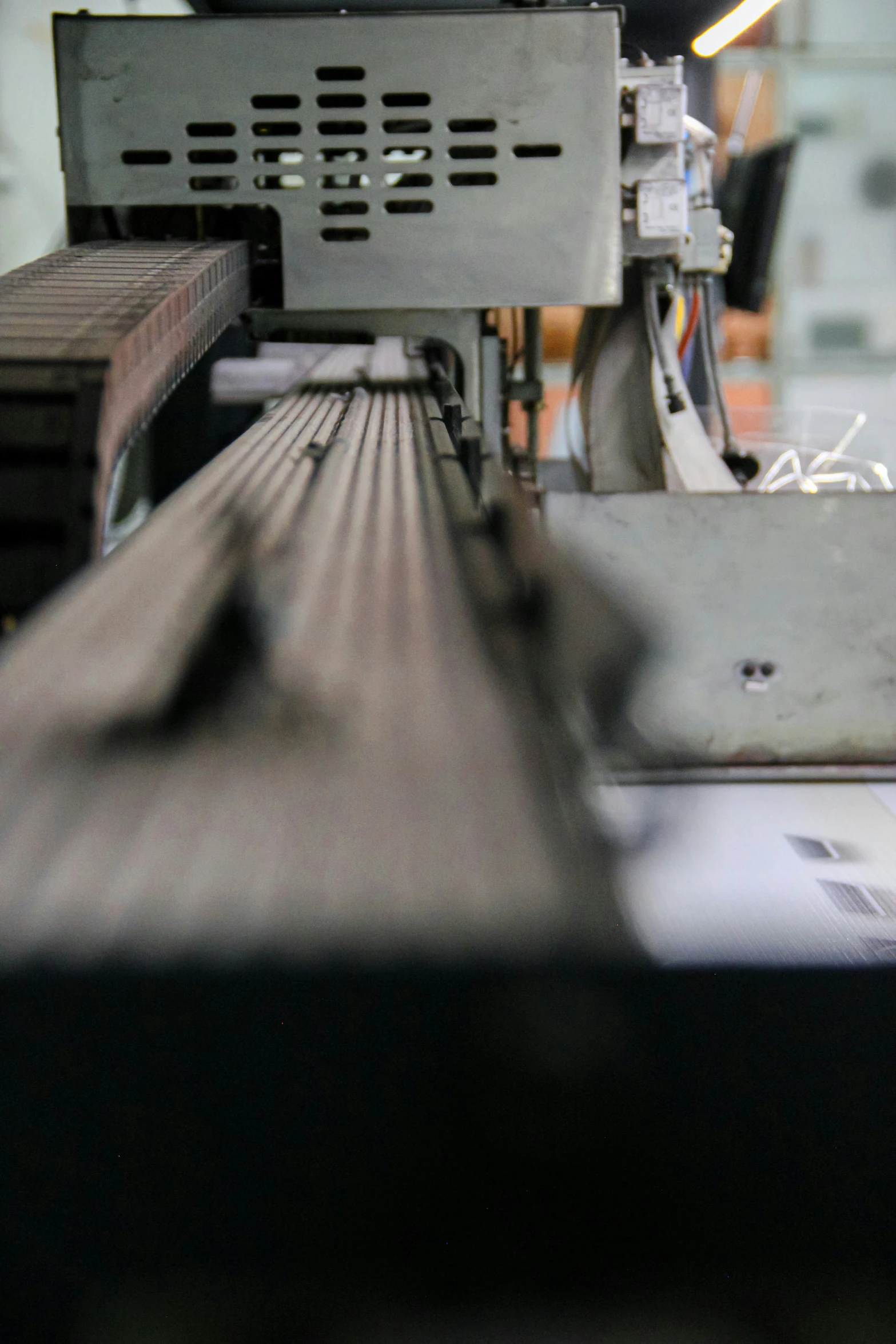 a machine working on a metal object with a table underneath