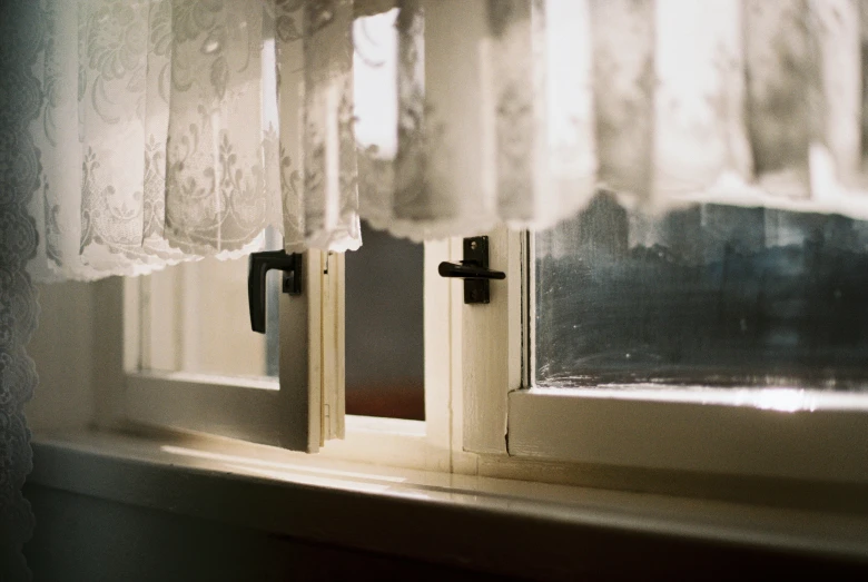 two closed window sills on a white curtain