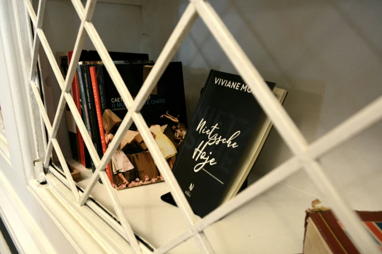 books sitting on top of a table behind a wire fence