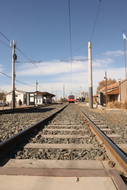 some old railway tracks with a red truck on one side