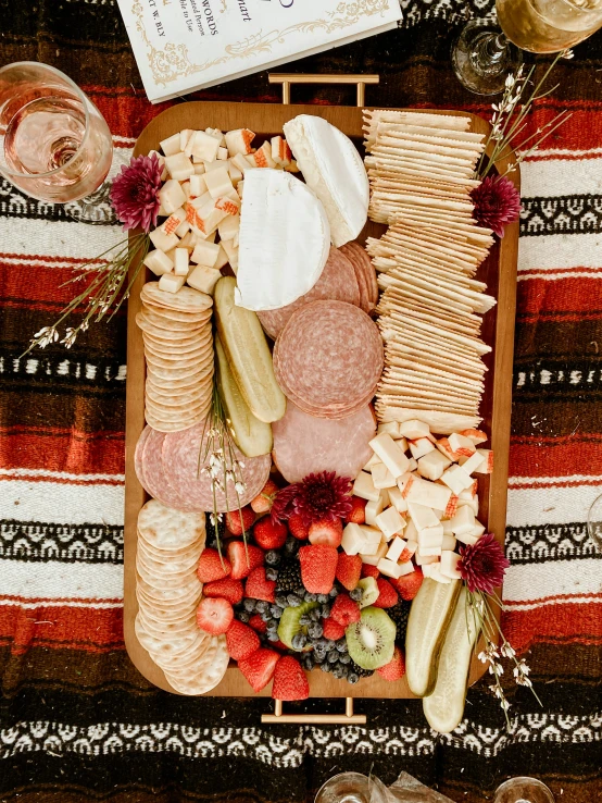 a tray full of cheese, ers, meat and fruit