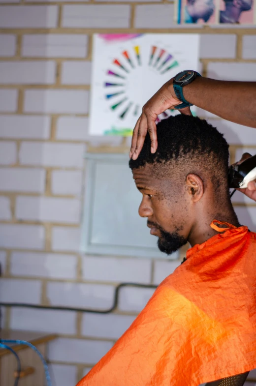 a man getting his hair cut while in the barber shop