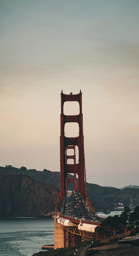 a small boat floats beneath the golden gate bridge