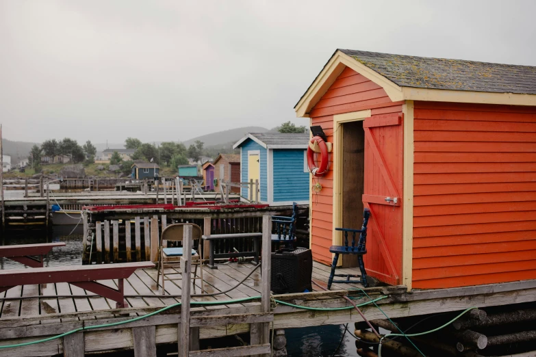 a red building on the edge of a body of water