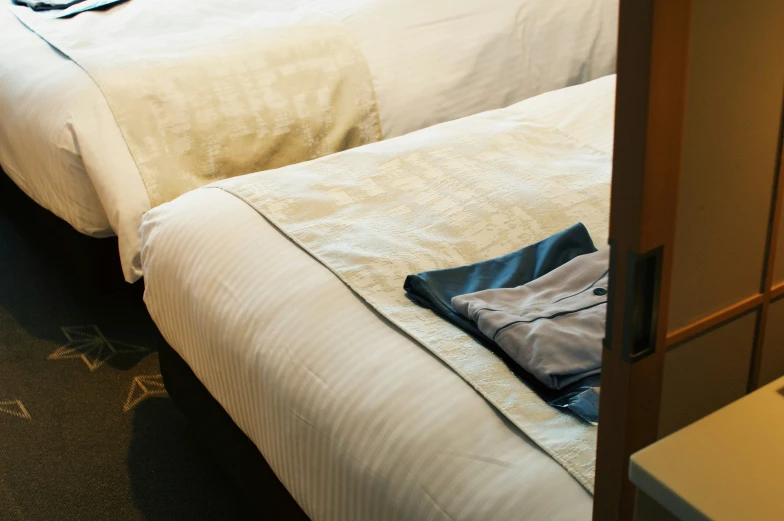 two bedding on a el room with a closed curtain