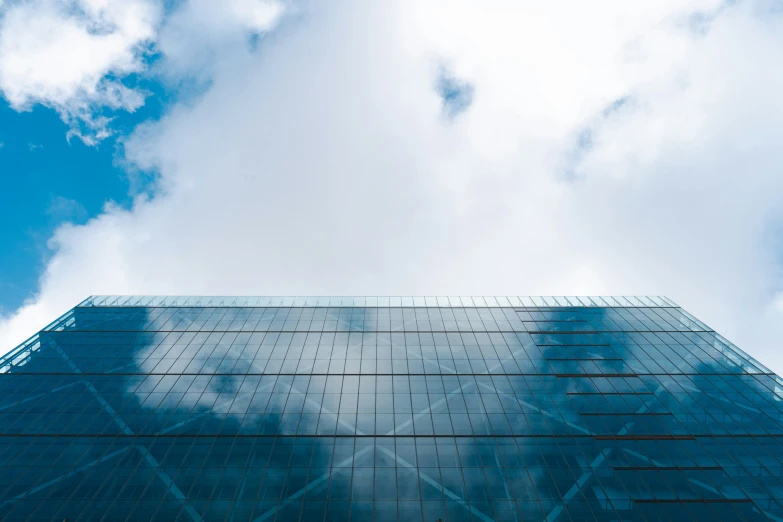 the sky is partly reflected in a building