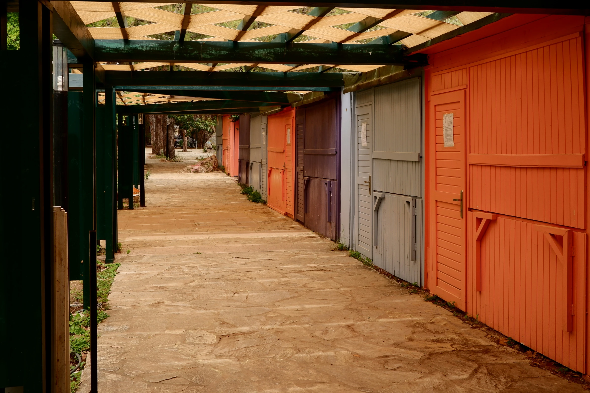 the exterior of an old building, with wooden stalls