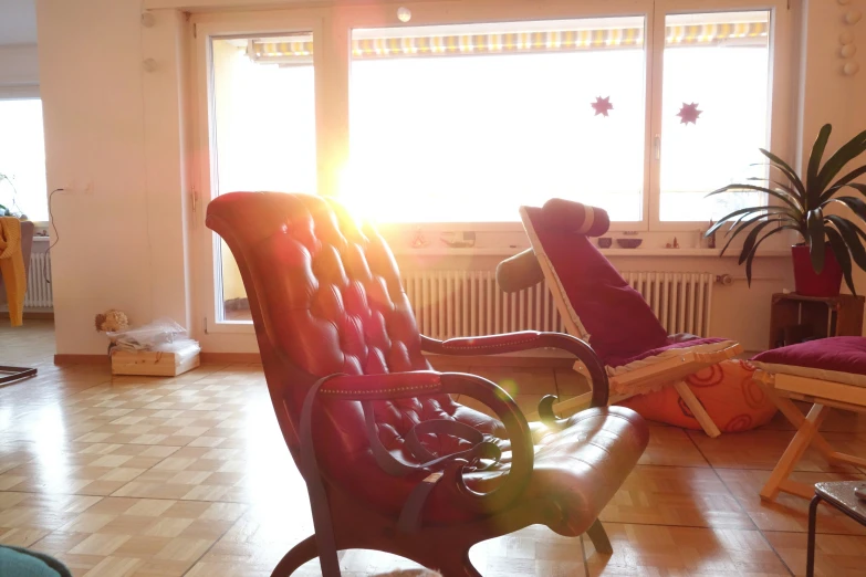 the sun is shining through the windows into a living room