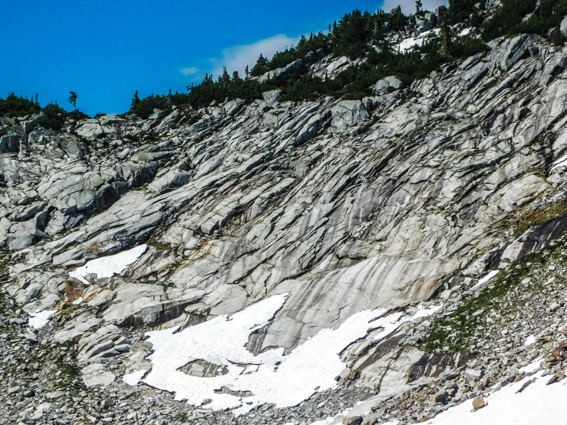 a skier skiing past large, rock formations on a snowy slope