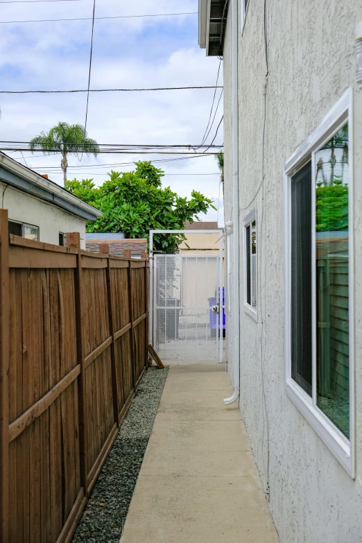 a house with a white fence and brown walls