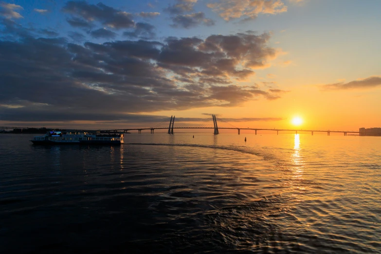 a long line boat floating across the water