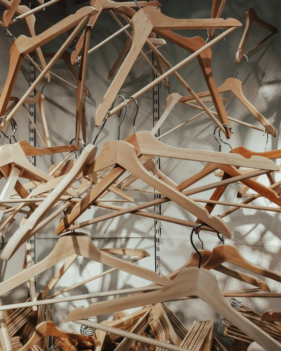 an art work consisting of wooden clothes hangers