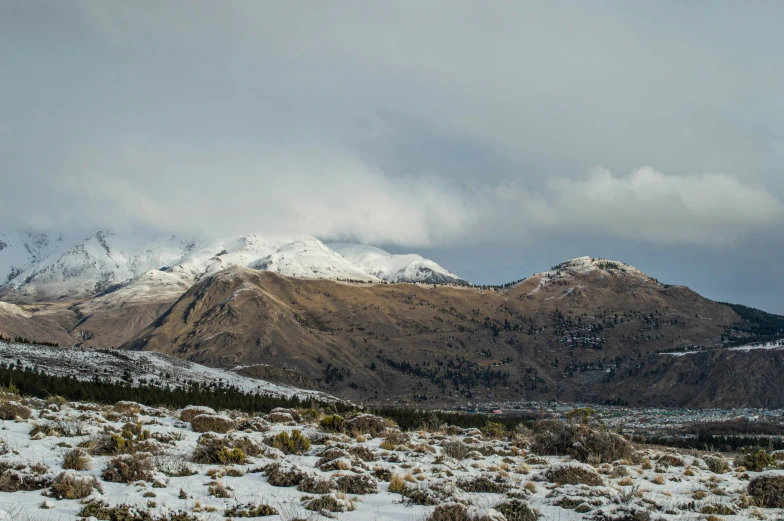 a couple of snow covered mountains in the distance