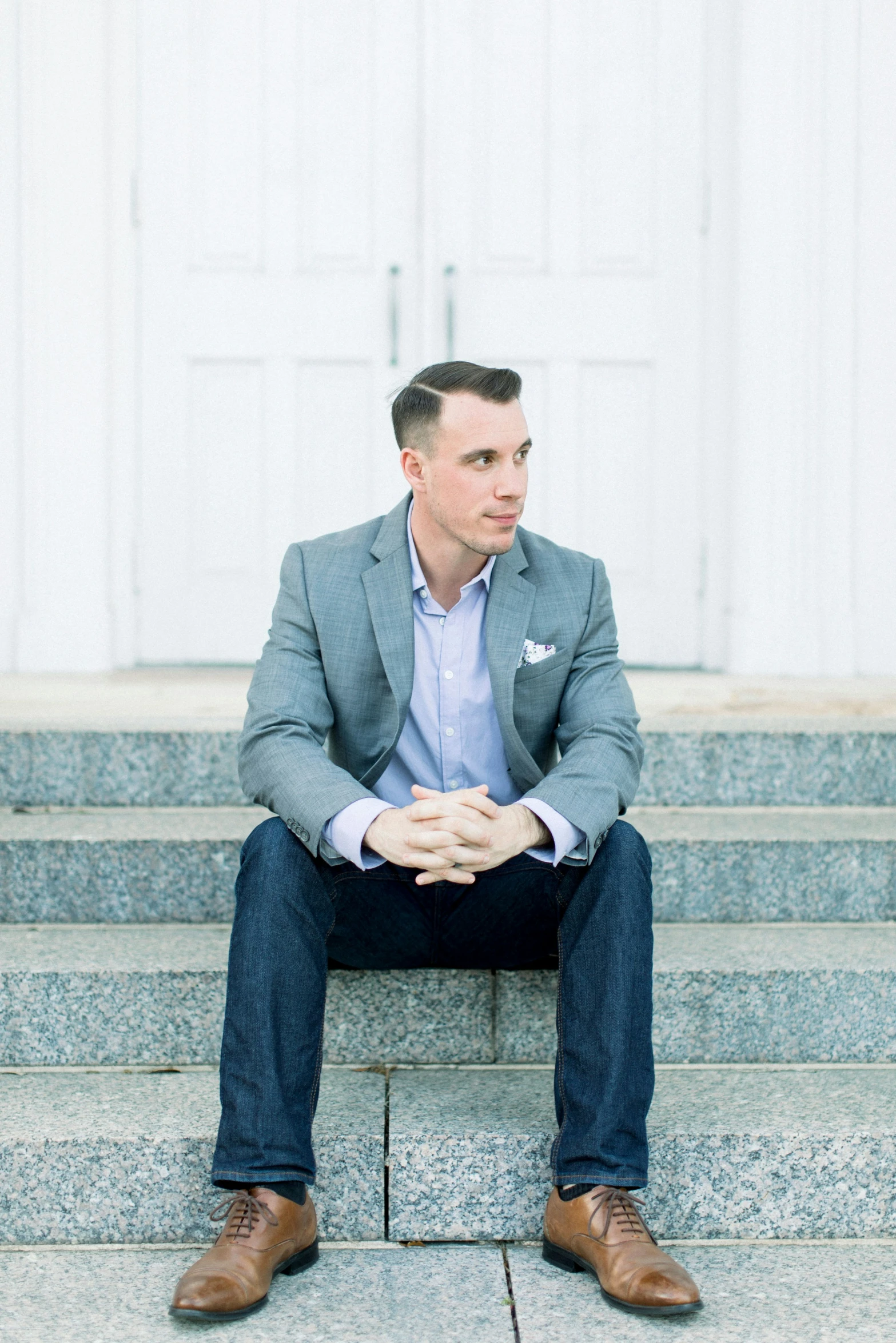 a man sitting on steps and looking away from the camera