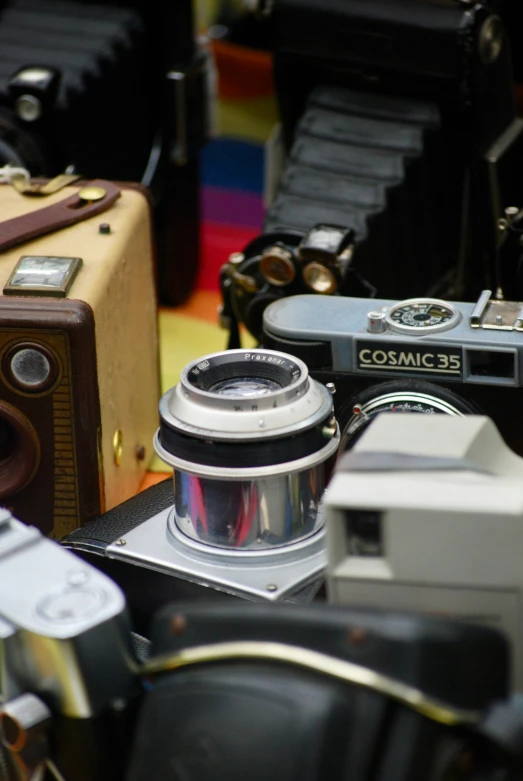 antique cameras sit on display at a flea market