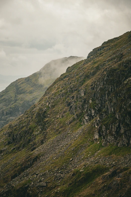 a lone bench sitting on the side of a hill