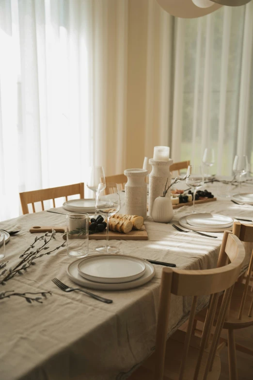 a dinner table set with plates and silverware