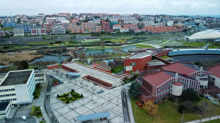 a big building with red tiled roofs and some buildings near by