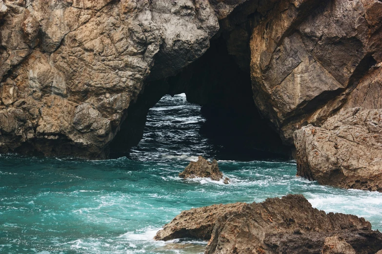 a man wading through some very thin rocks