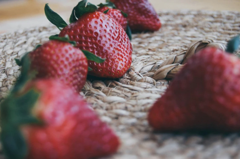 a closeup s of strawberries and their leaves