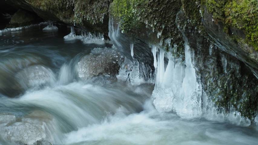 some water flowing down a small stream near rocks