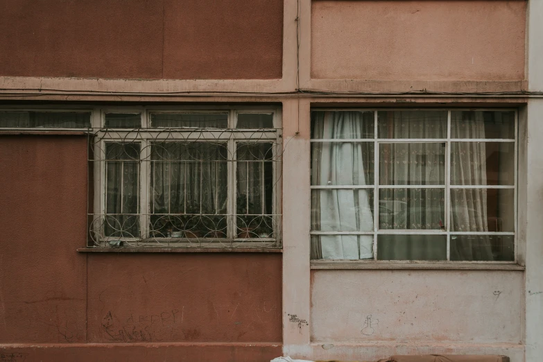 an empty bench and window are seen from outside