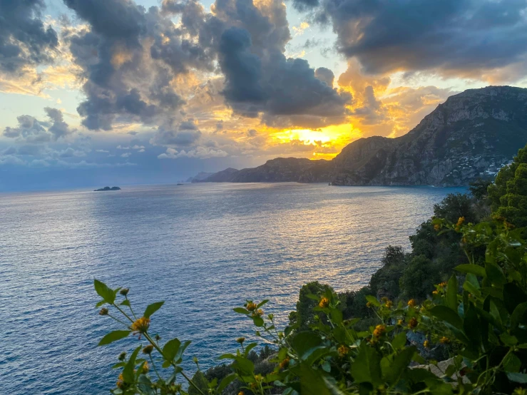 a large body of water sitting below a mountain side