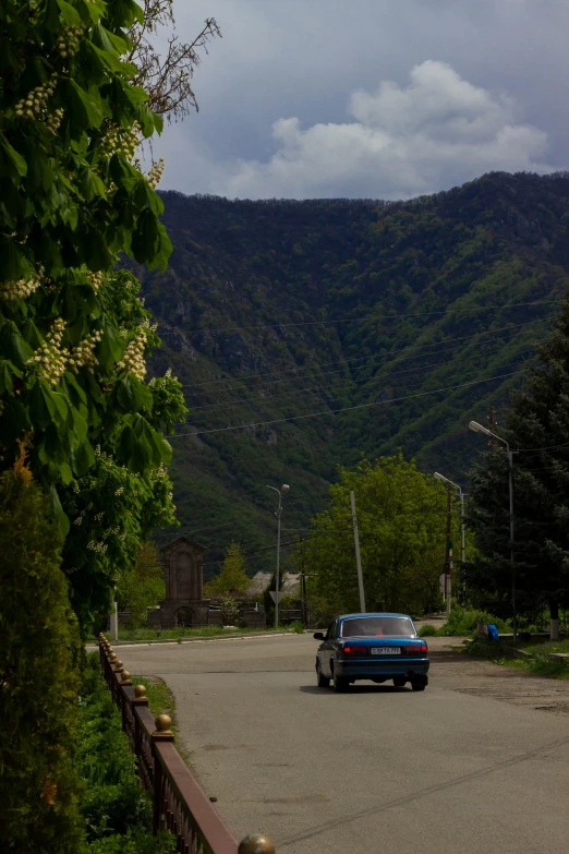 a truck is parked on the street with hills behind it