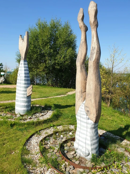 large stone sculptures with the shape of hands and legs