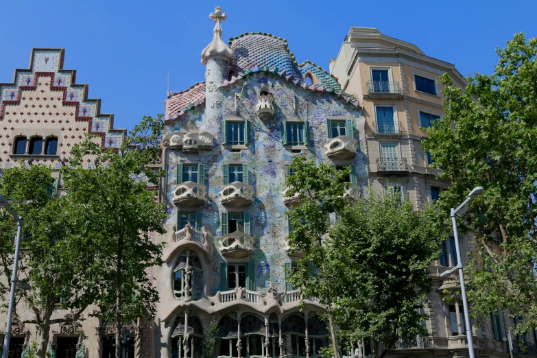 ornate building with tiled windows in front of trees