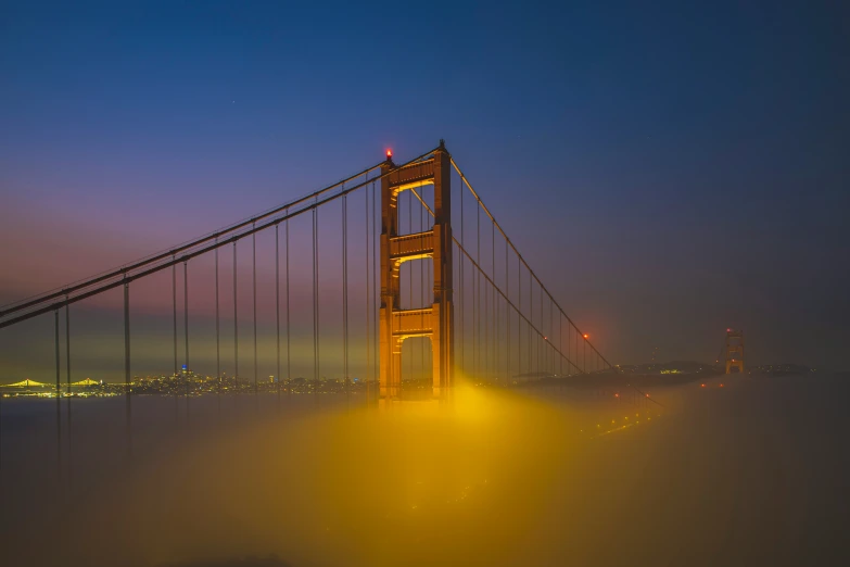 golden gate bridge in the fog at night