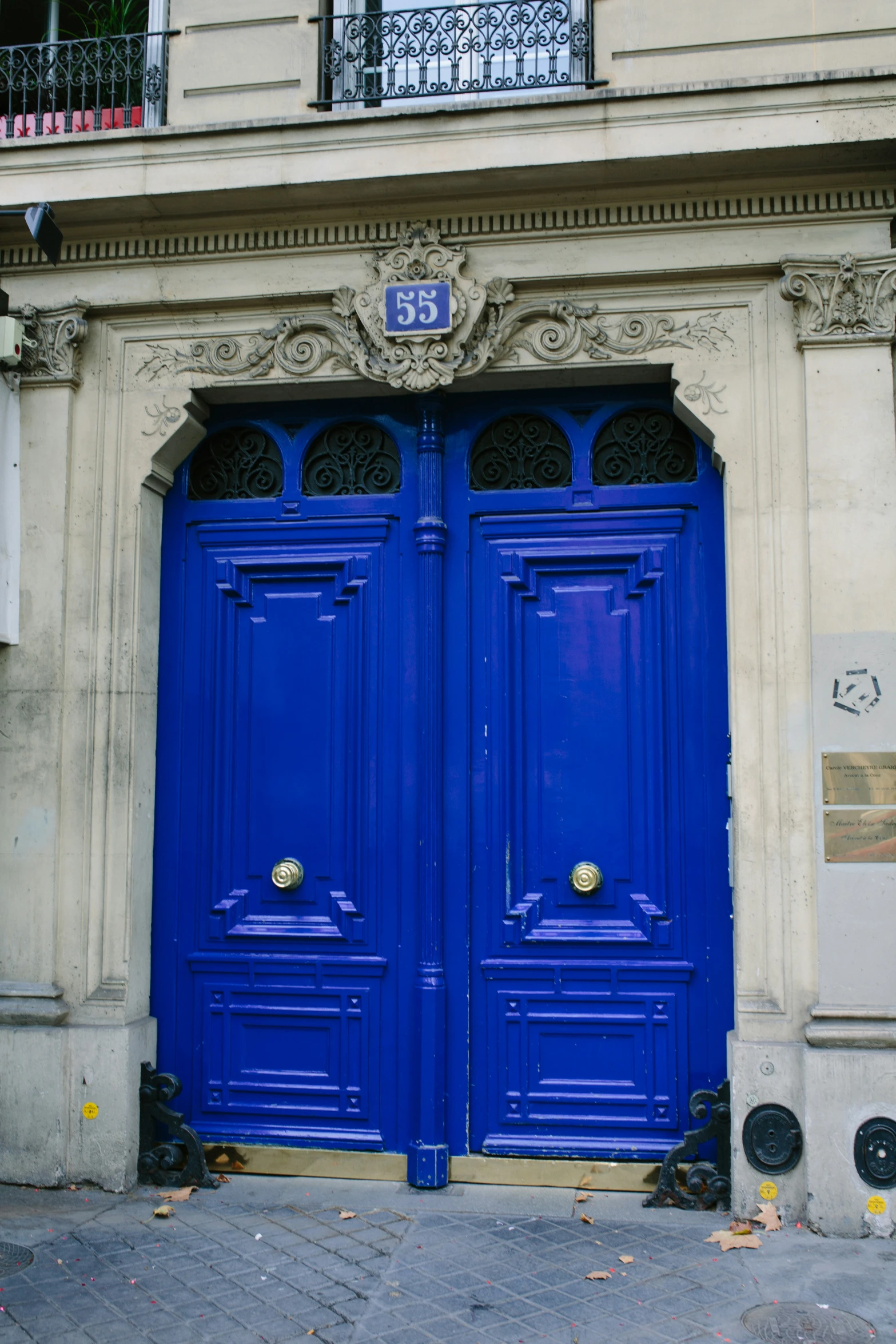 two blue double doors on an old building