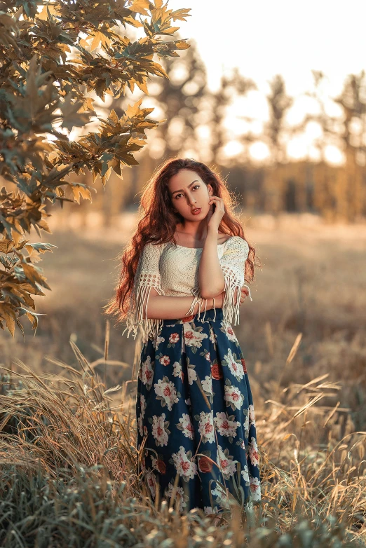 the girl stands in the field looking up