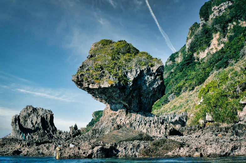 an airplane is flying over a rocky island