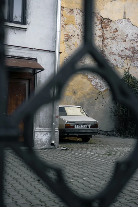 an old car is parked in front of a house