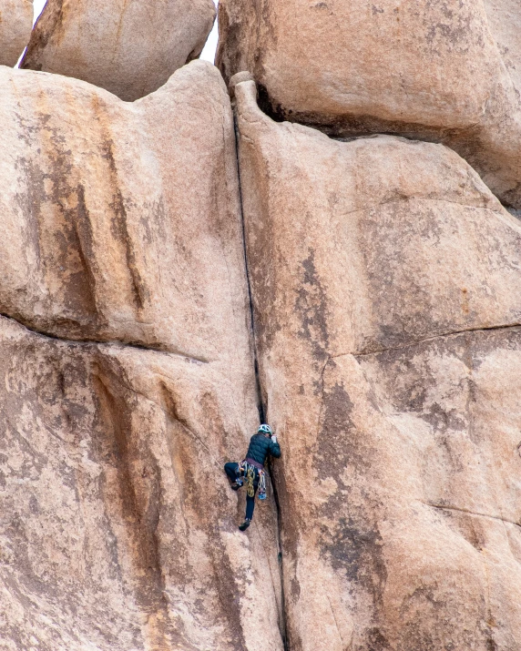 a person climbing up a cliff and holding the handle