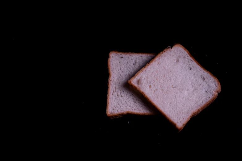 two slices of white bread cut into squares