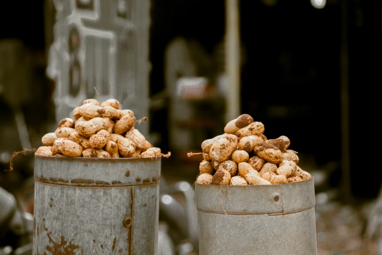 two buckets filled with food sit on the street