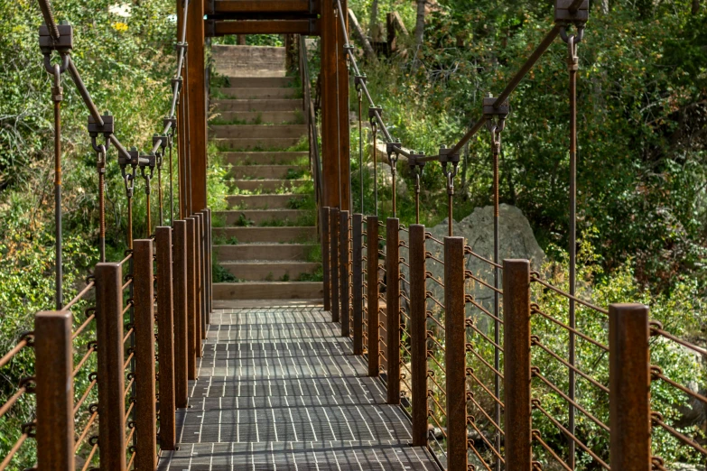 stairs on top of metal railing with a pathway below