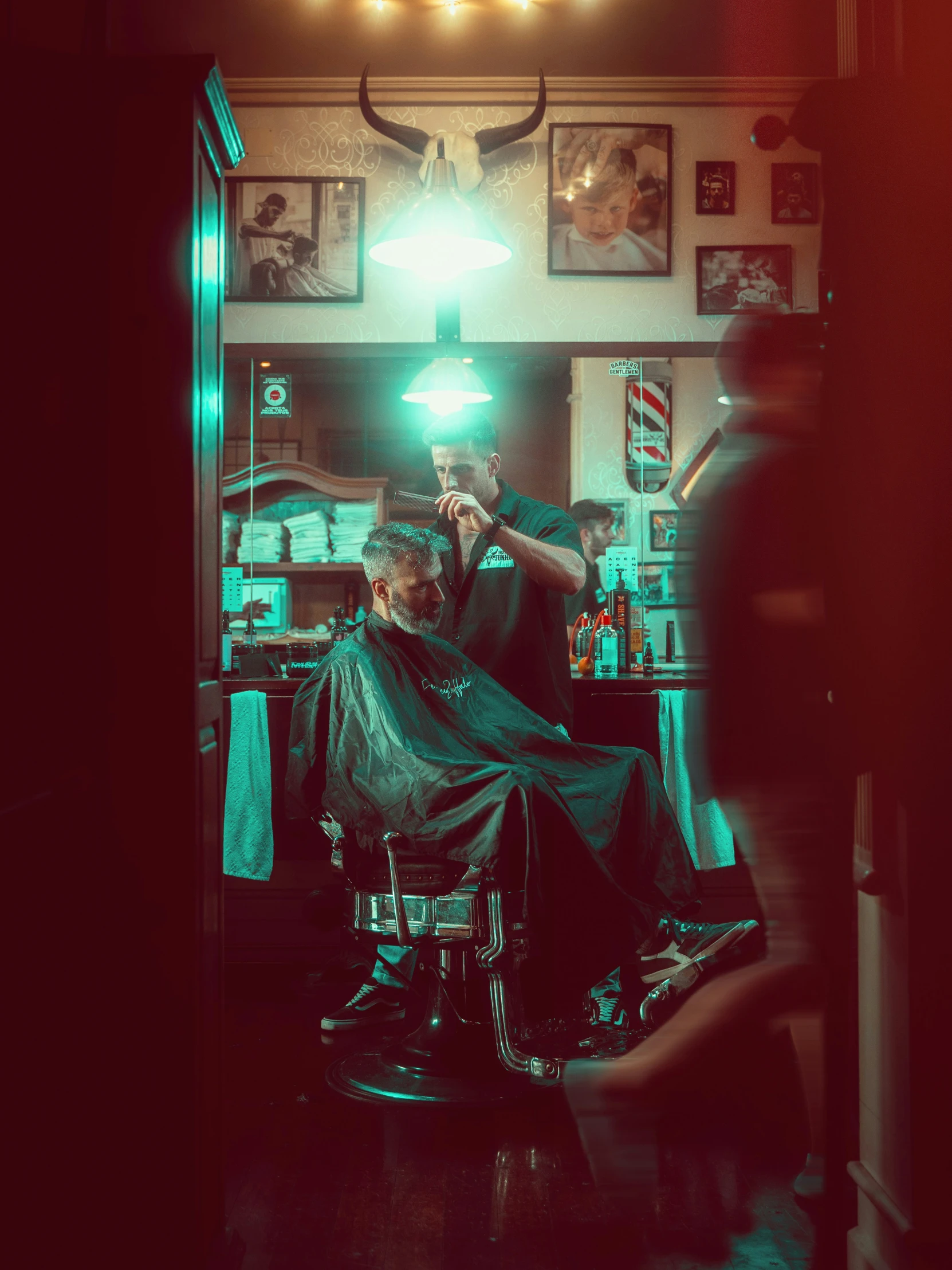 a man sitting at a barber shop  his hair